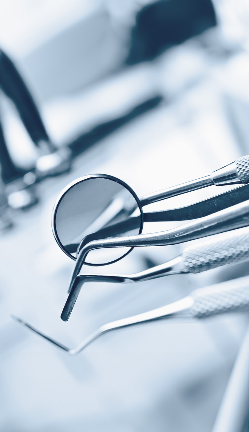 The image shows a modern dental or medical office interior with a dental chair, equipment, and a clean, professional environment.